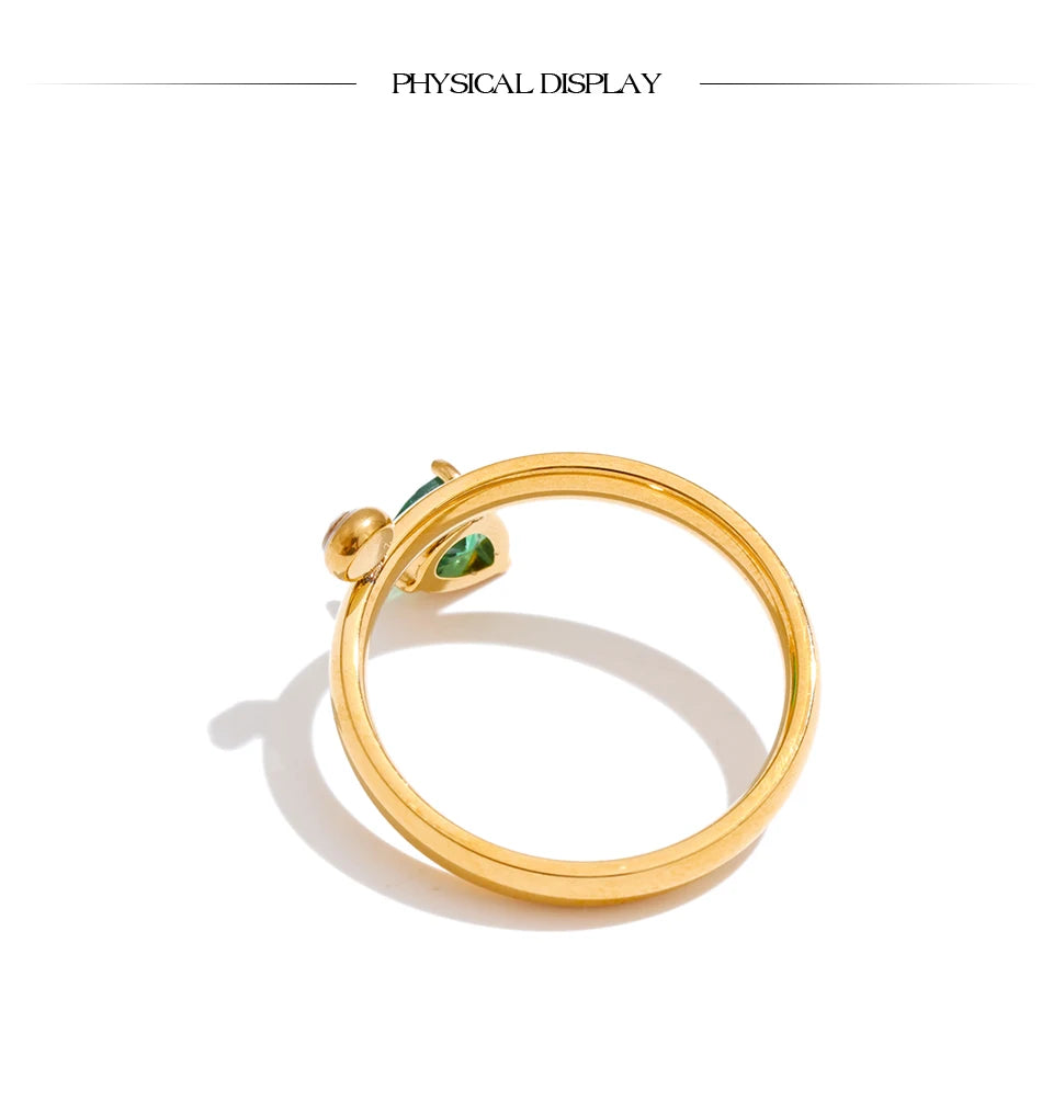 Green cubic zirconia geometric ring in 18K gold-plated stainless steel with cubic zirconia.
