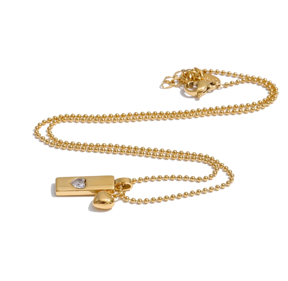 Cubic zirconia heart geometric necklace in gold-plated stainless steel with cubic zirconia.