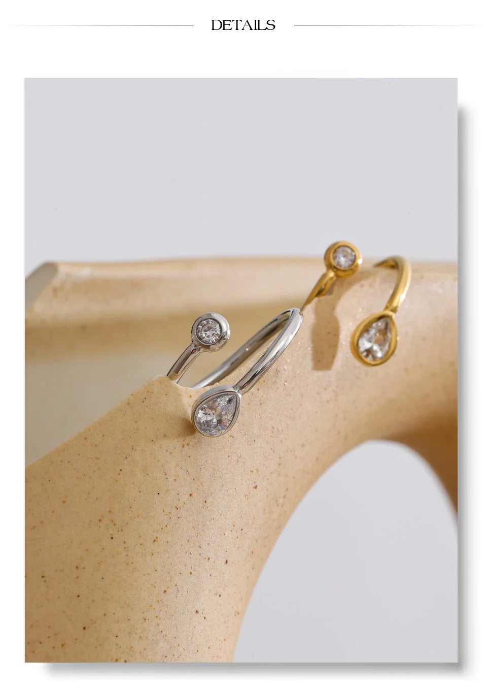 Cubic zirconia geometric ring in 18K gold-plated stainless steel with cubic zirconia.