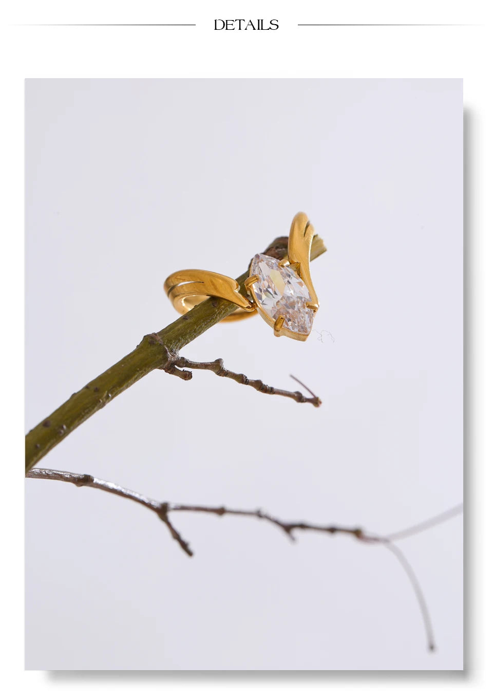 Cubic zirconia geometric ring in 18K gold-plated stainless steel with cubic zirconia.
