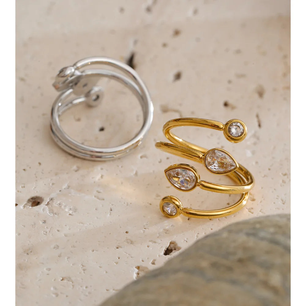 Cubic zirconia geometric layered ring in 18K gold-plated stainless steel with cubic zirconia.