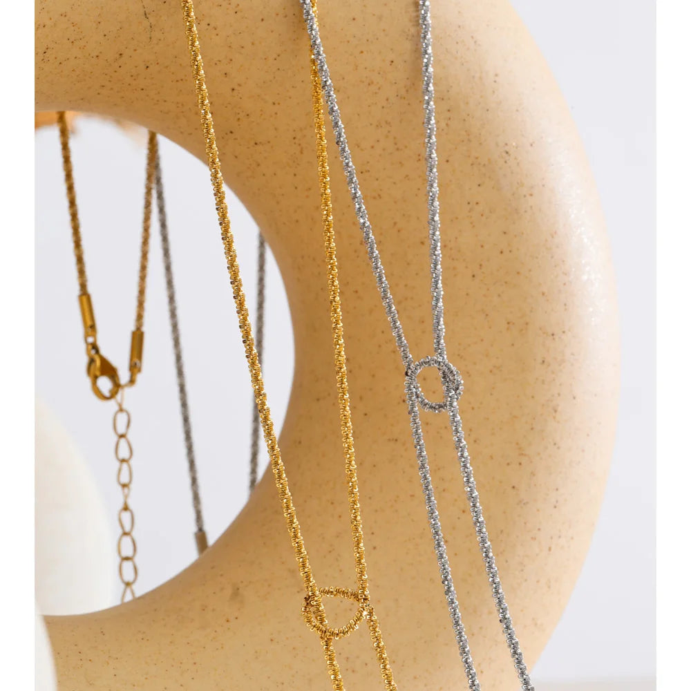 Cubic zirconia geometric chain necklace in gold-plated stainless steel with cubic zirconia.
