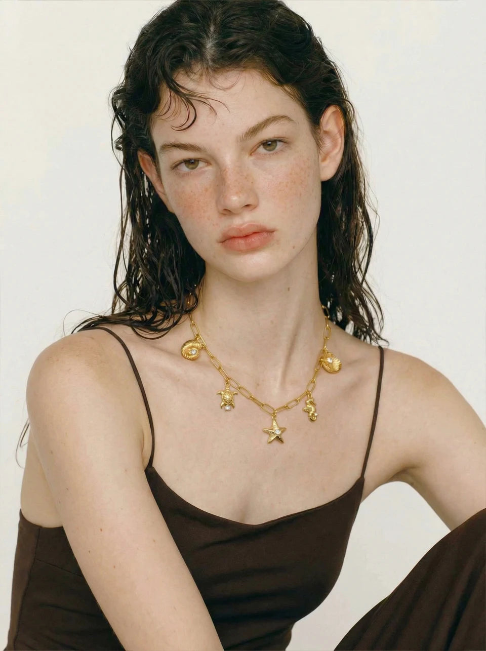 Cubic zirconia shell star necklace in gold-plated stainless steel with cubic zirconia and shell.