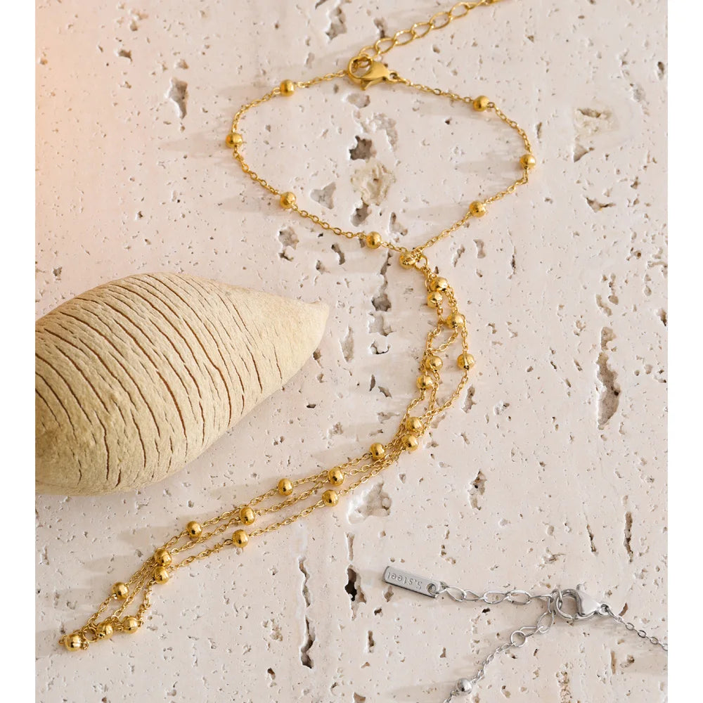 Beaded geometric chain necklace in gold-plated stainless steel.