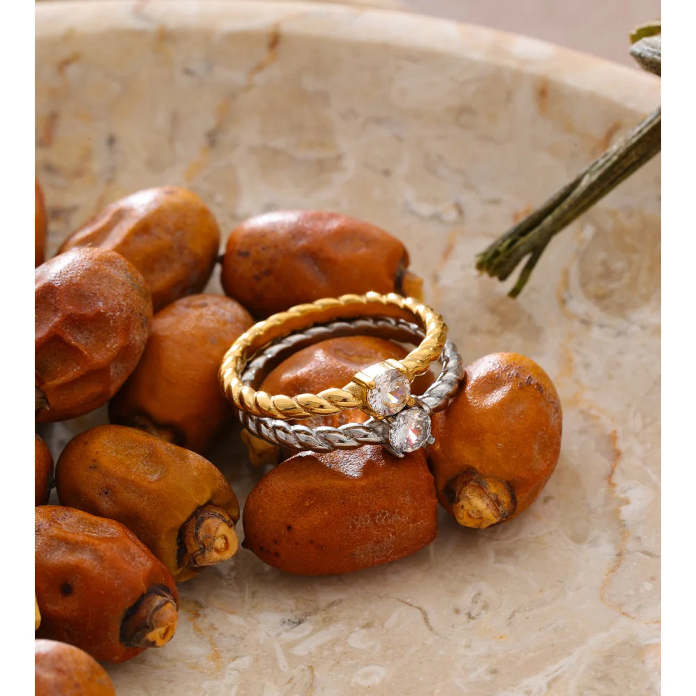 Cubic zirconia geometric ring in 18K gold-plated stainless steel with cubic zirconia.
