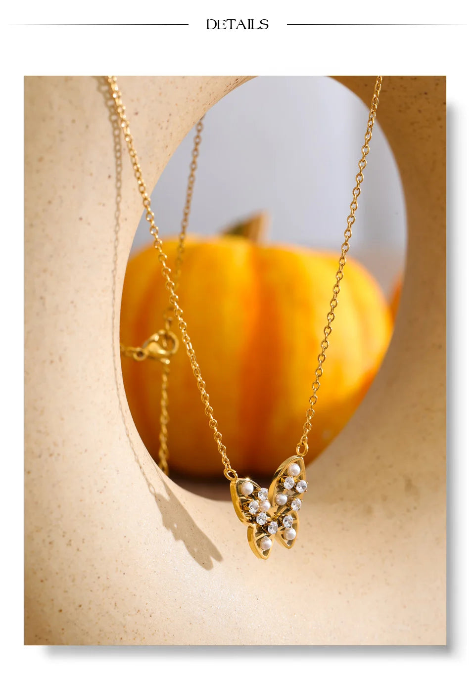 Cubic zirconia pearl butterfly necklace in gold-plated stainless steel with pearl and cubic zirconia.