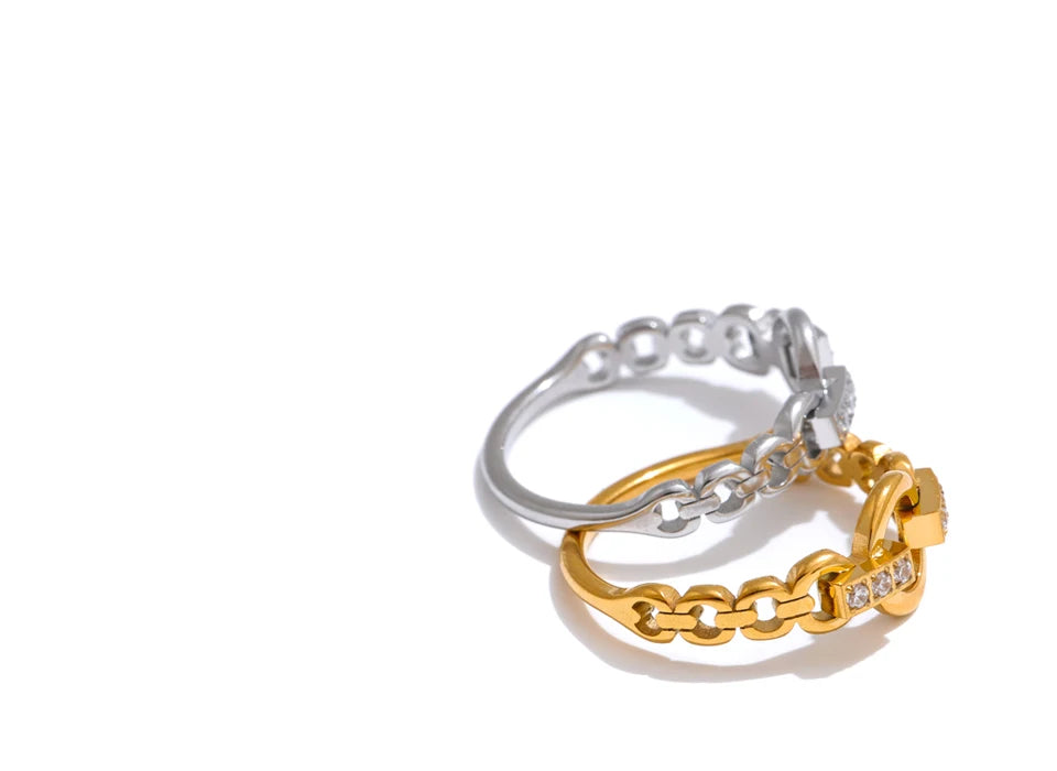 Cubic zirconia geometric ring in gold-plated stainless steel with cubic zirconia.