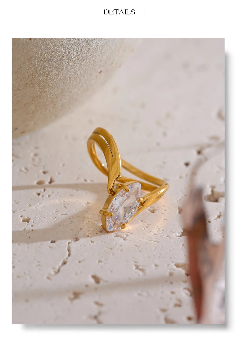 Cubic zirconia geometric ring in 18K gold-plated stainless steel with cubic zirconia.