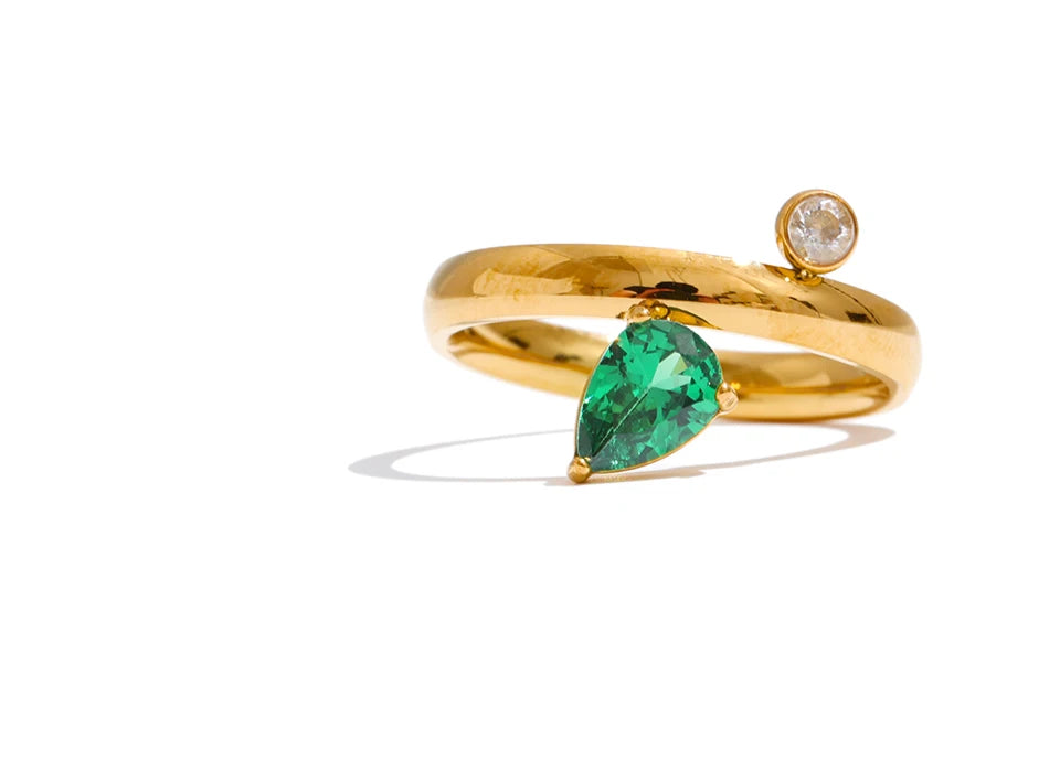 Green cubic zirconia geometric ring in 18K gold-plated stainless steel with cubic zirconia.