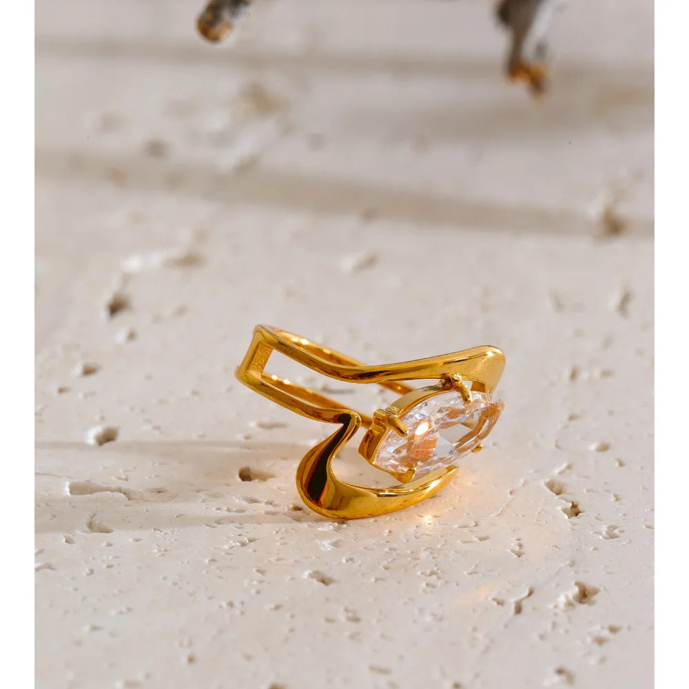 Cubic zirconia geometric ring in 18K gold-plated stainless steel with cubic zirconia.