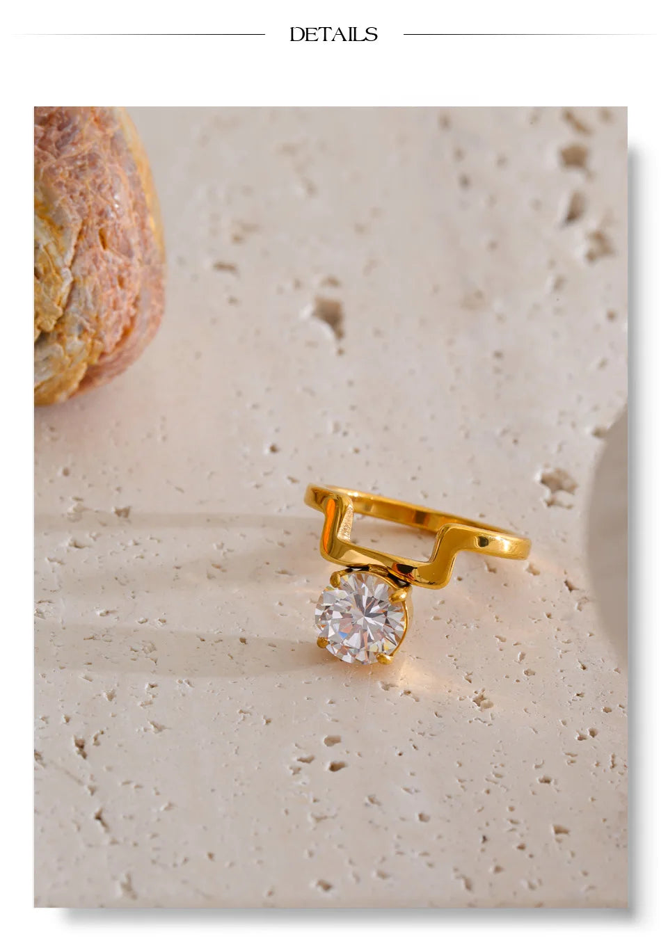 Cubic zirconia geometric ring in 18K gold-plated stainless steel with cubic zirconia.