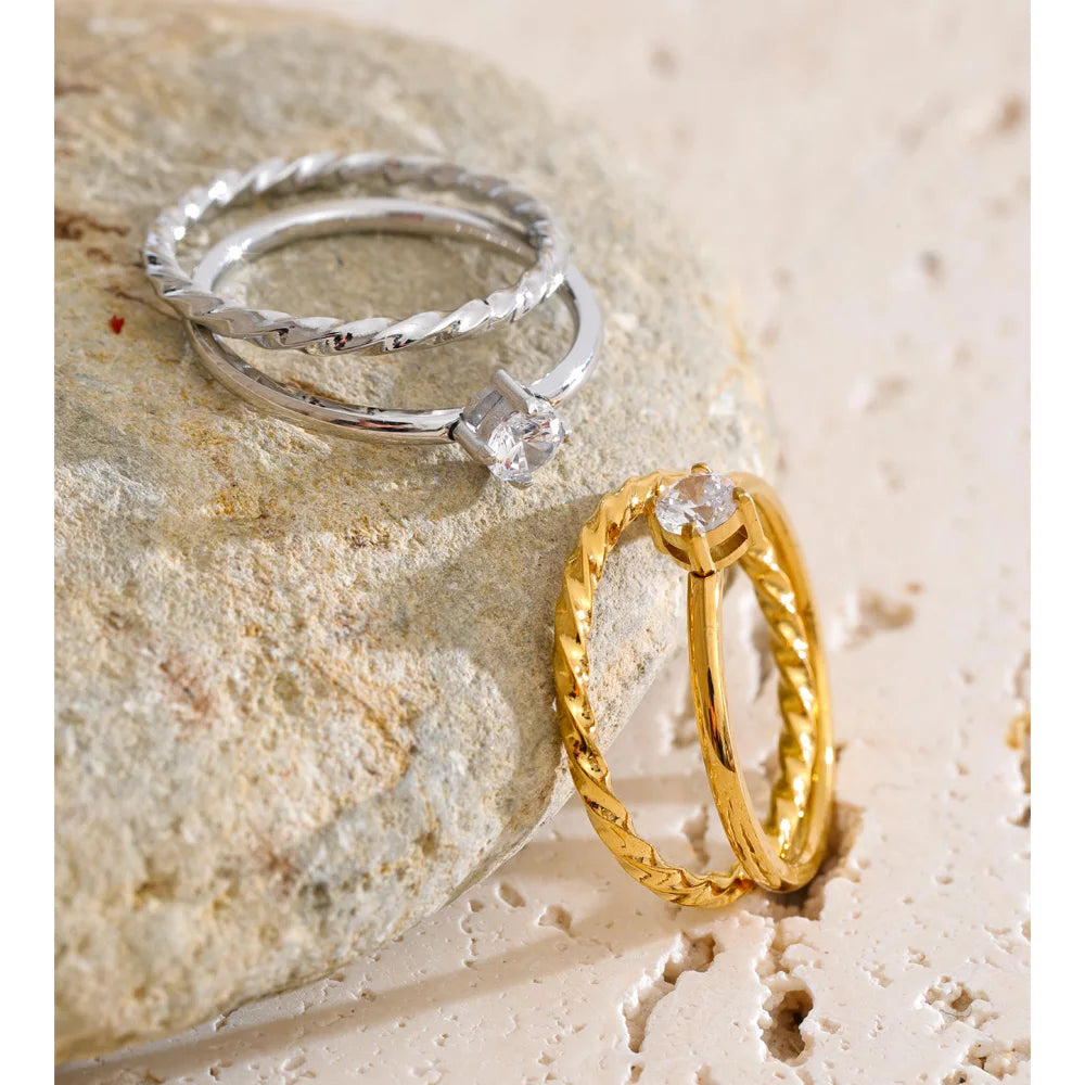 Cubic zirconia geometric ring in gold-plated stainless steel with cubic zirconia.