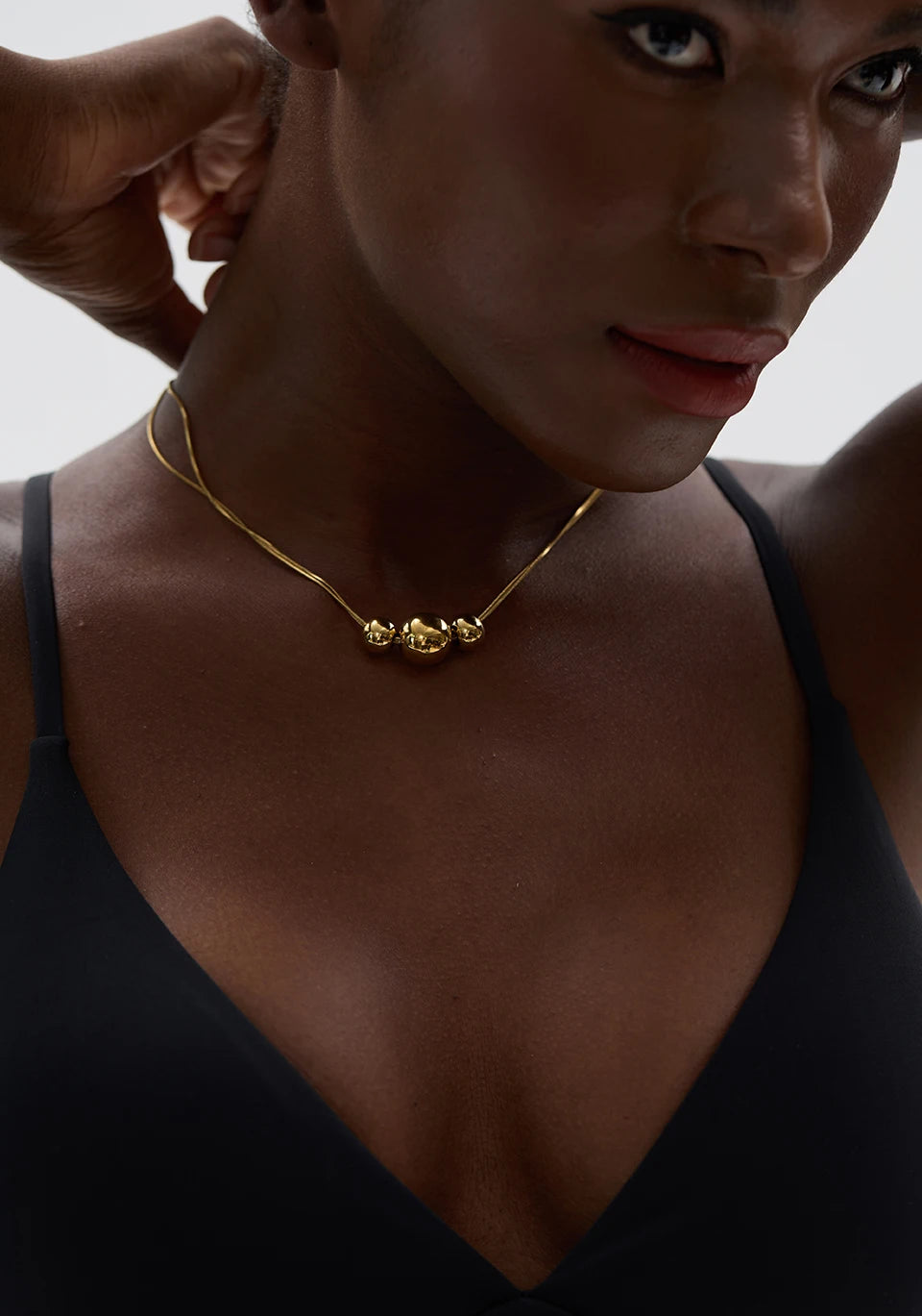 Beaded geometric chain necklace in gold-plated 316L stainless steel.