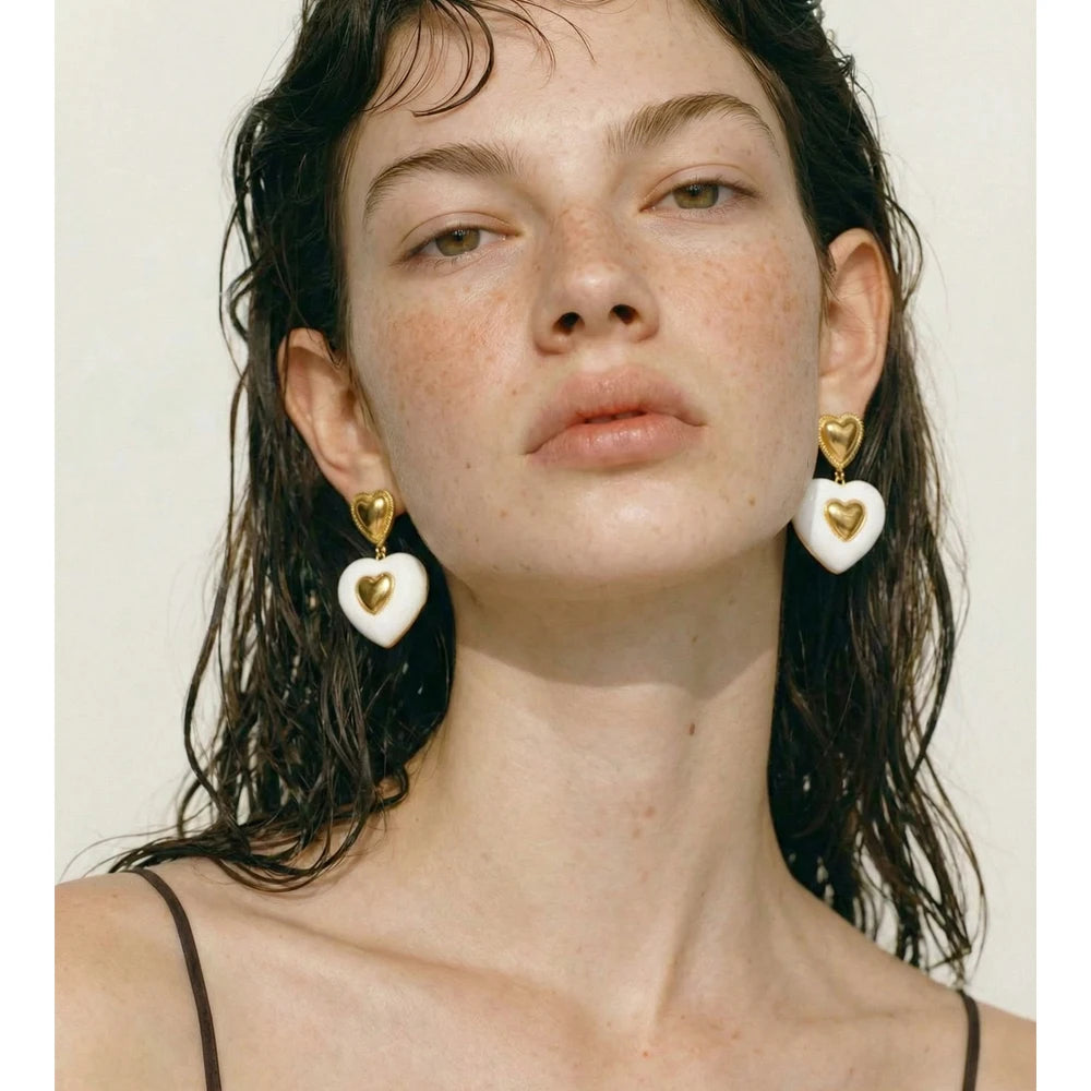 White enamel heart earrings in gold-plated stainless steel with enamel.