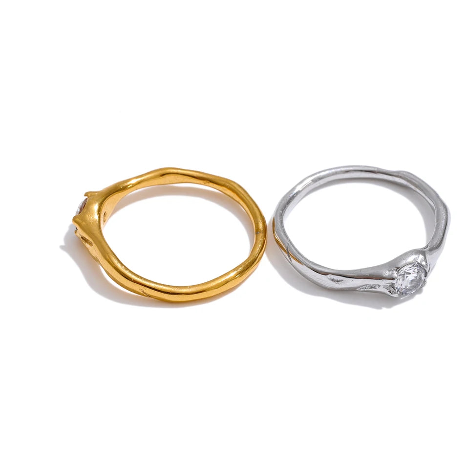 Cubic zirconia geometric ring in 18K gold-plated stainless steel with cubic zirconia.