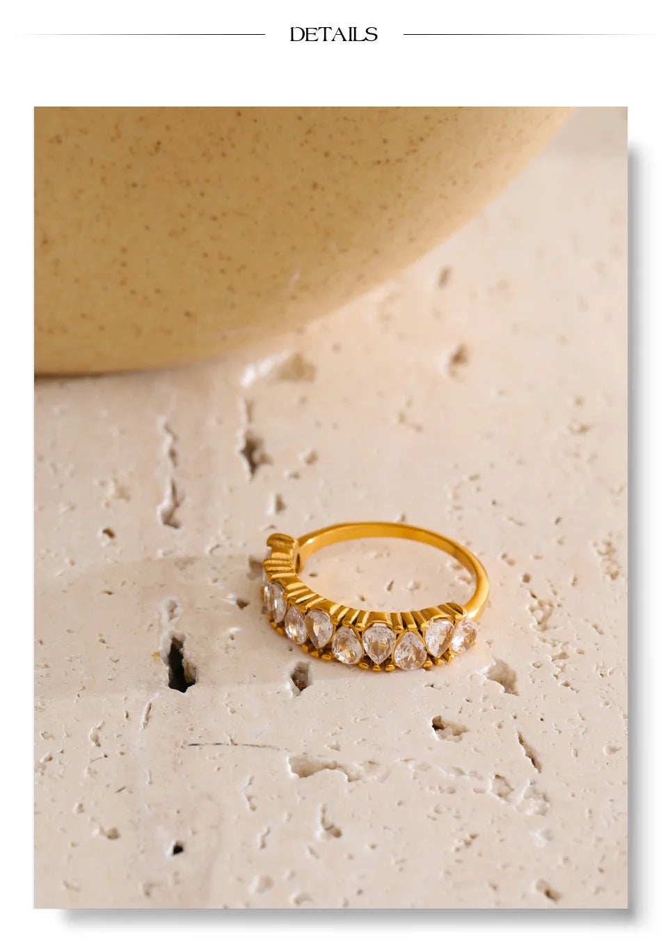 Cubic zirconia geometric ring in 18K gold-plated stainless steel with cubic zirconia.