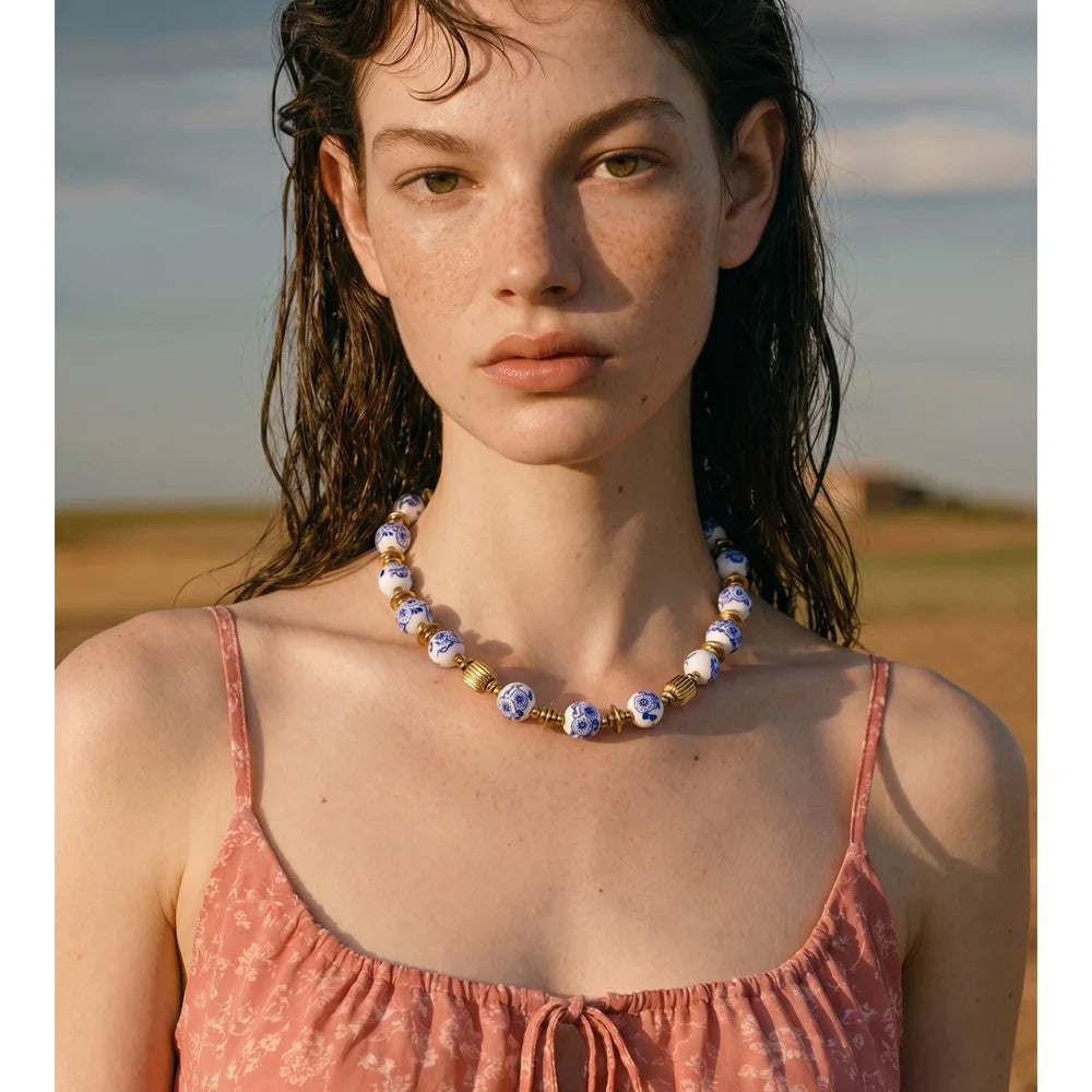 Blue flower beaded necklace in gold-plated stainless steel.
