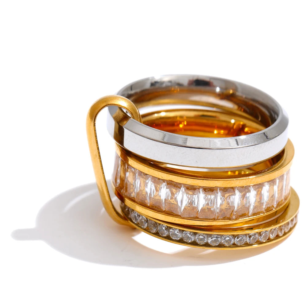 Cubic zirconia geometric layered ring in 18K gold-plated stainless steel with cubic zirconia.