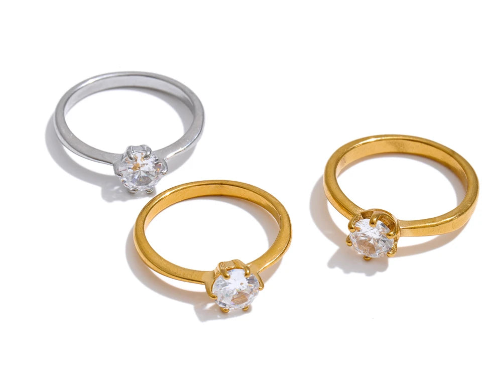 Cubic zirconia geometric ring in 18K gold-plated stainless steel with cubic zirconia.