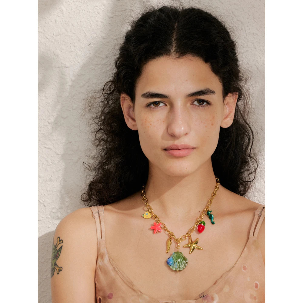 Shell enamel star necklace in gold-plated stainless steel with shell and enamel.