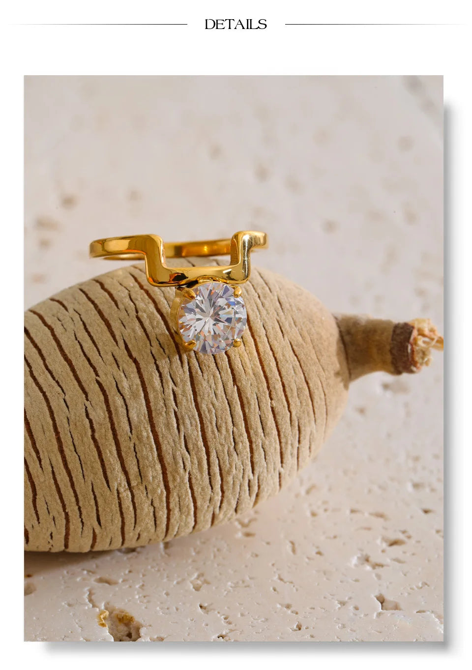 Cubic zirconia geometric ring in 18K gold-plated stainless steel with cubic zirconia.
