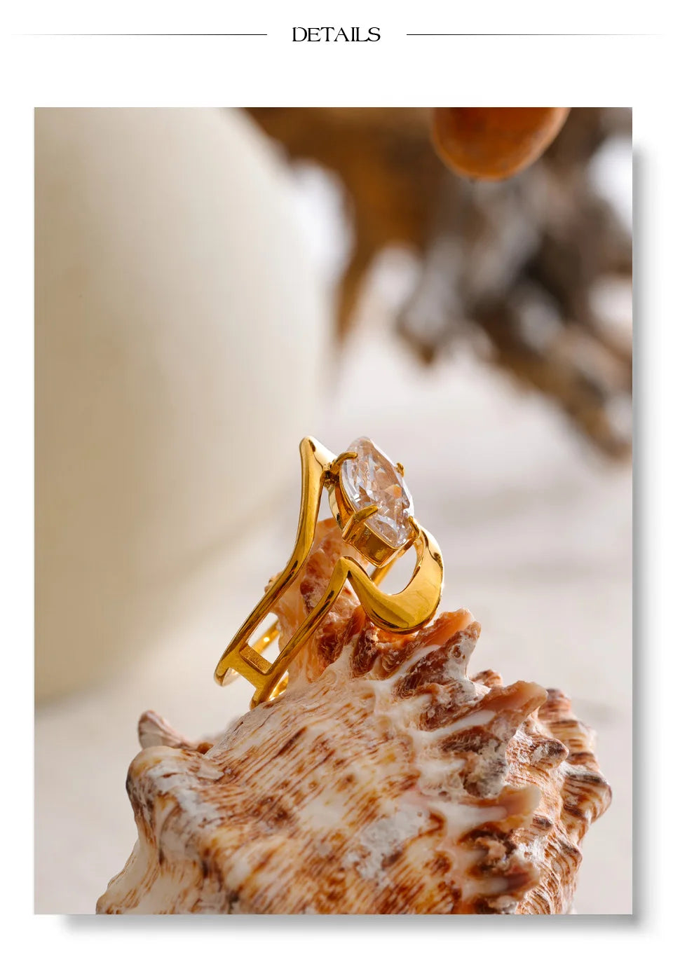 Cubic zirconia geometric ring in 18K gold-plated stainless steel with cubic zirconia.