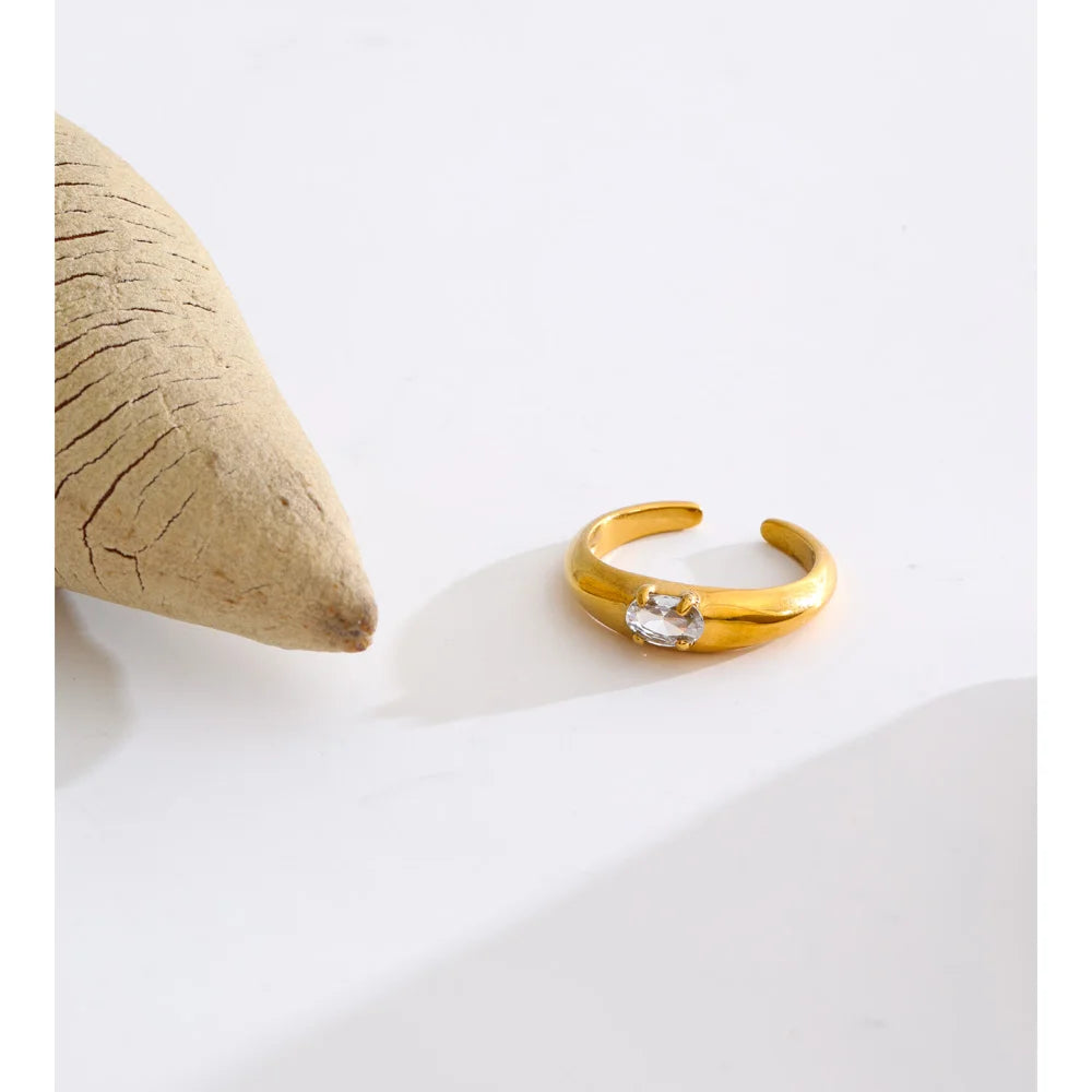 Cubic zirconia geometric ring in 18K gold-plated stainless steel with cubic zirconia.