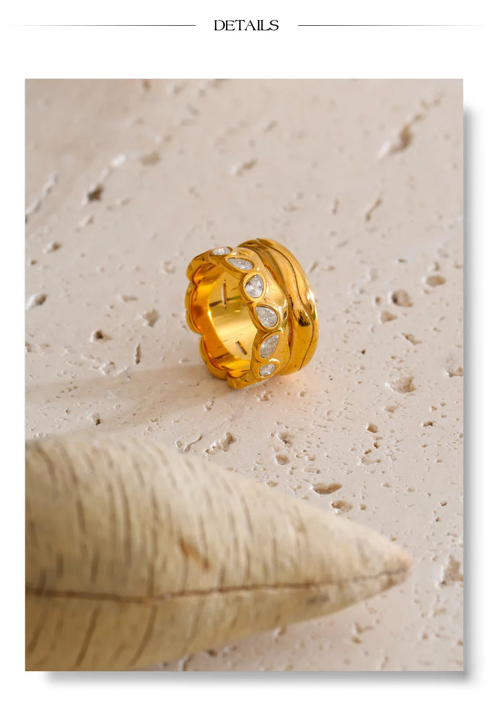 Cubic zirconia geometric ring in 18K gold-plated stainless steel with cubic zirconia.