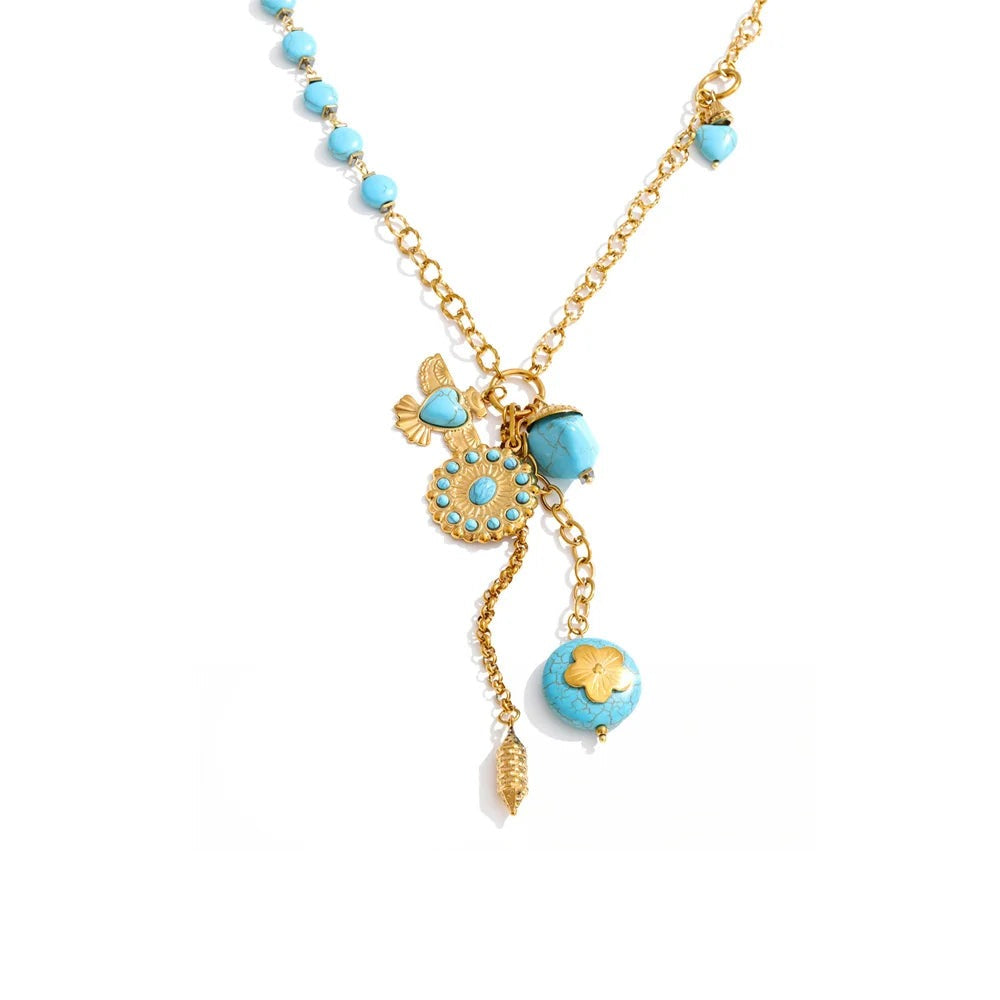 Gold-plated stainless steel necklace with turquoise stones and a blue flower pendant.