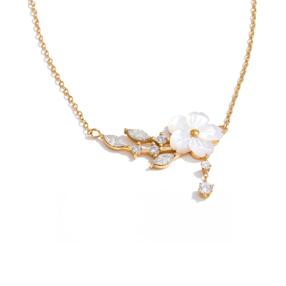 Gold-plated stainless steel necklace with cubic zirconia and shell pendant featuring a white flower and leaves.