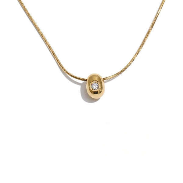 Gold-plated stainless steel necklace with cubic zirconia pendant.