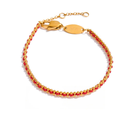 Gold-plated bracelet with red beads.