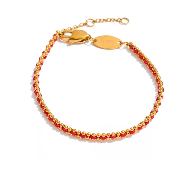 Gold-plated bracelet with red beads.