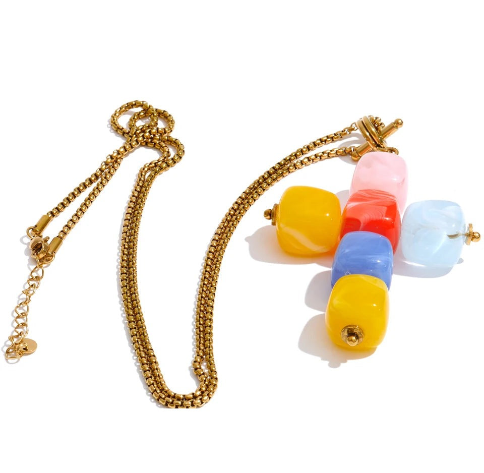 Resin acrylic cross necklace in gold-plated stainless steel with resin and acrylic.