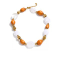 Gold-plated stainless steel necklace with resin beads featuring orange stones.