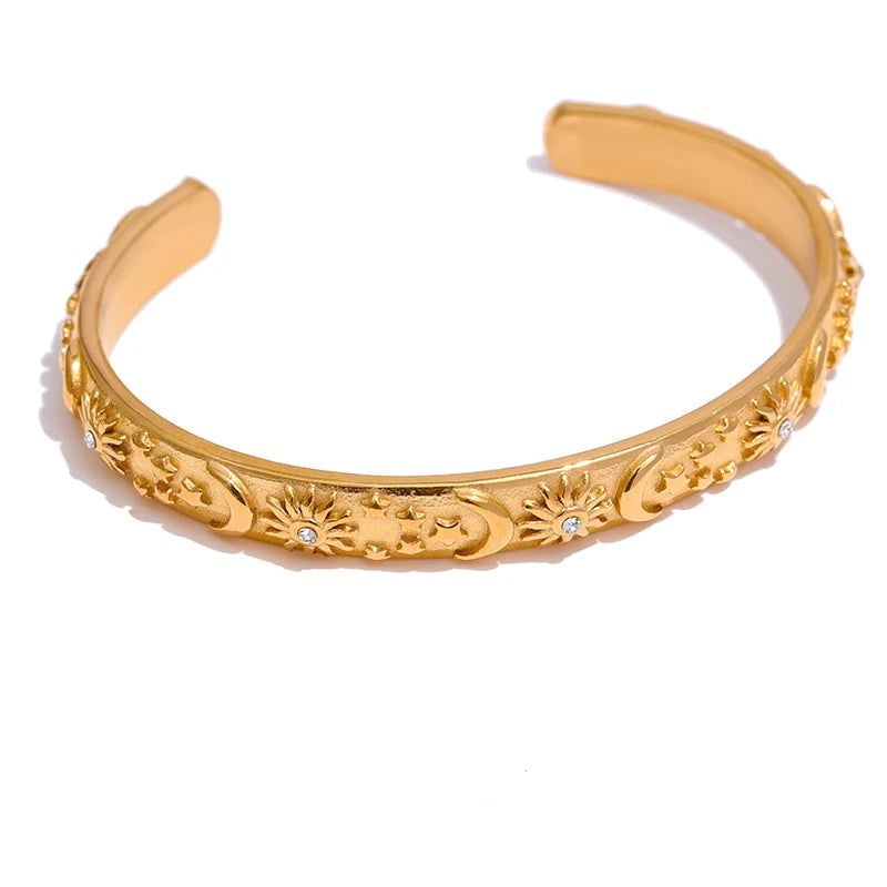 Gold-plated bracelet with a floral design.