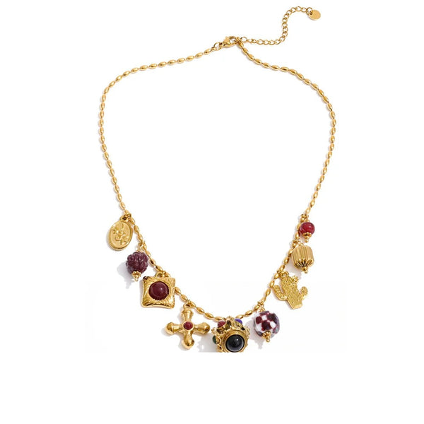 Gold-plated necklace with resin and acrylic details, featuring a cross pendant and multiple colorful stones.