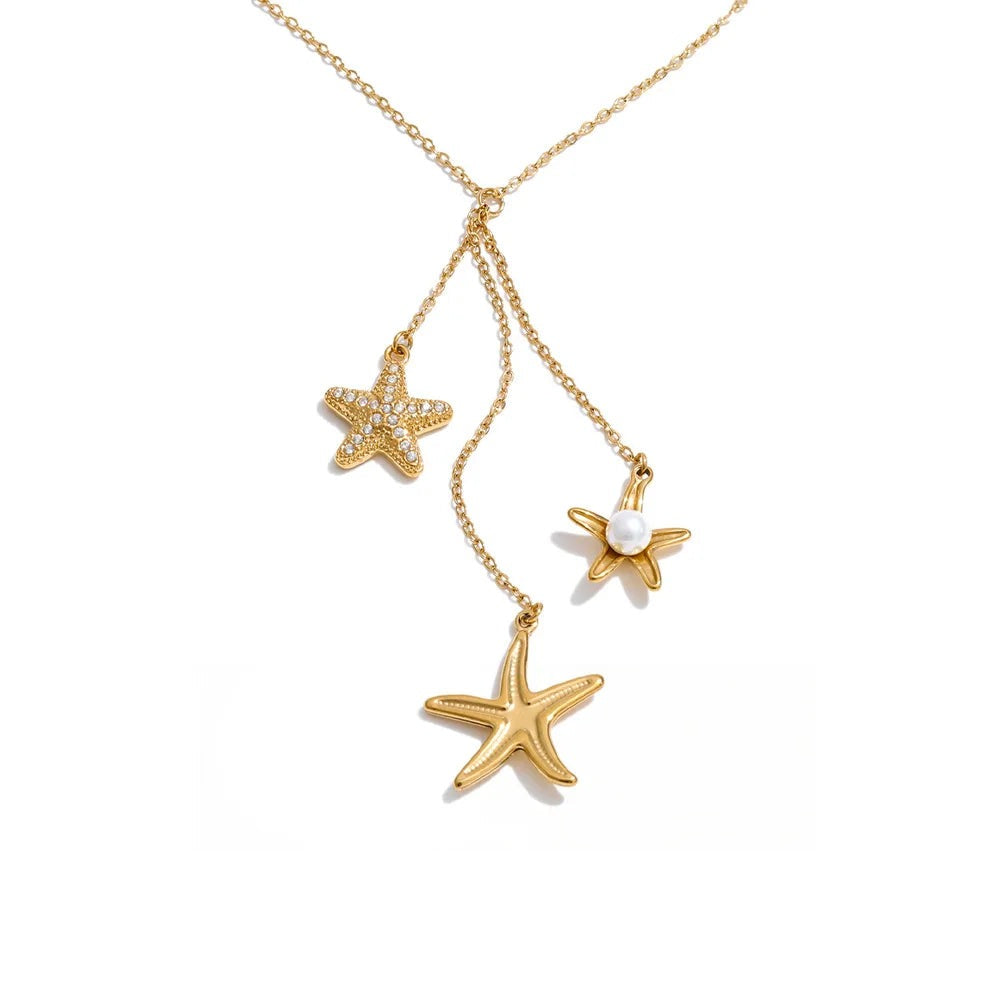 Gold-plated stainless steel necklace with pearl and cubic zirconia accents, featuring a starfish pendant and two additional starfish charms.