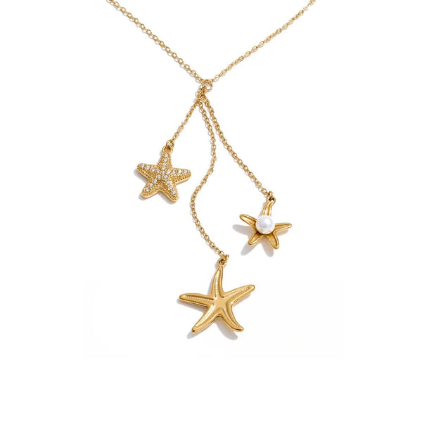 Gold-plated stainless steel necklace with pearl and cubic zirconia accents, featuring a starfish pendant and two additional starfish charms.