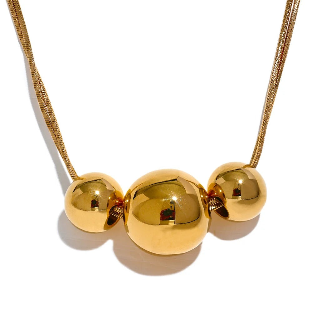 Gold-plated necklace with three spherical beads.