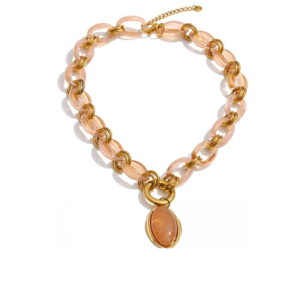 Gold-plated stainless steel necklace with resin and acrylic, featuring a large oval pendant.