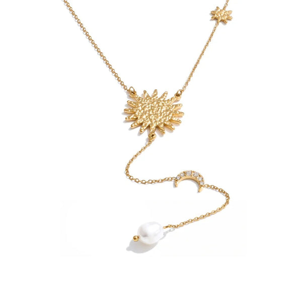 Gold-plated stainless steel necklace with freshwater pearl and cubic zirconia pendant featuring sunburst design.
