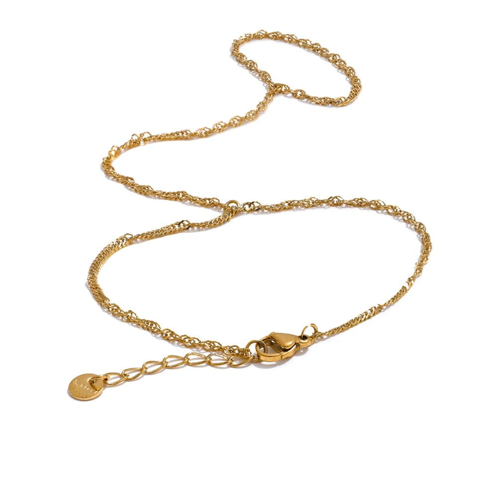 Gold-plated stainless steel bracelet with a small charm.