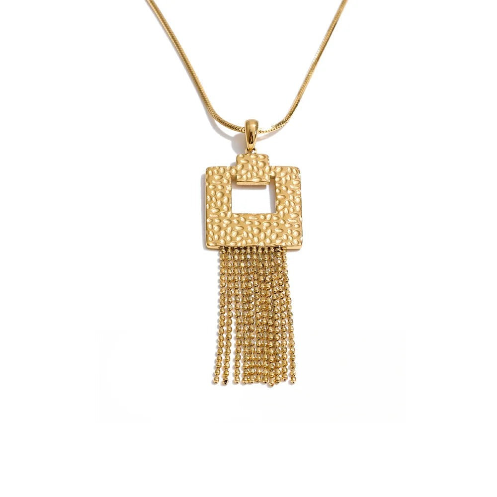 Gold-tone pendant with a tassel on a chain.