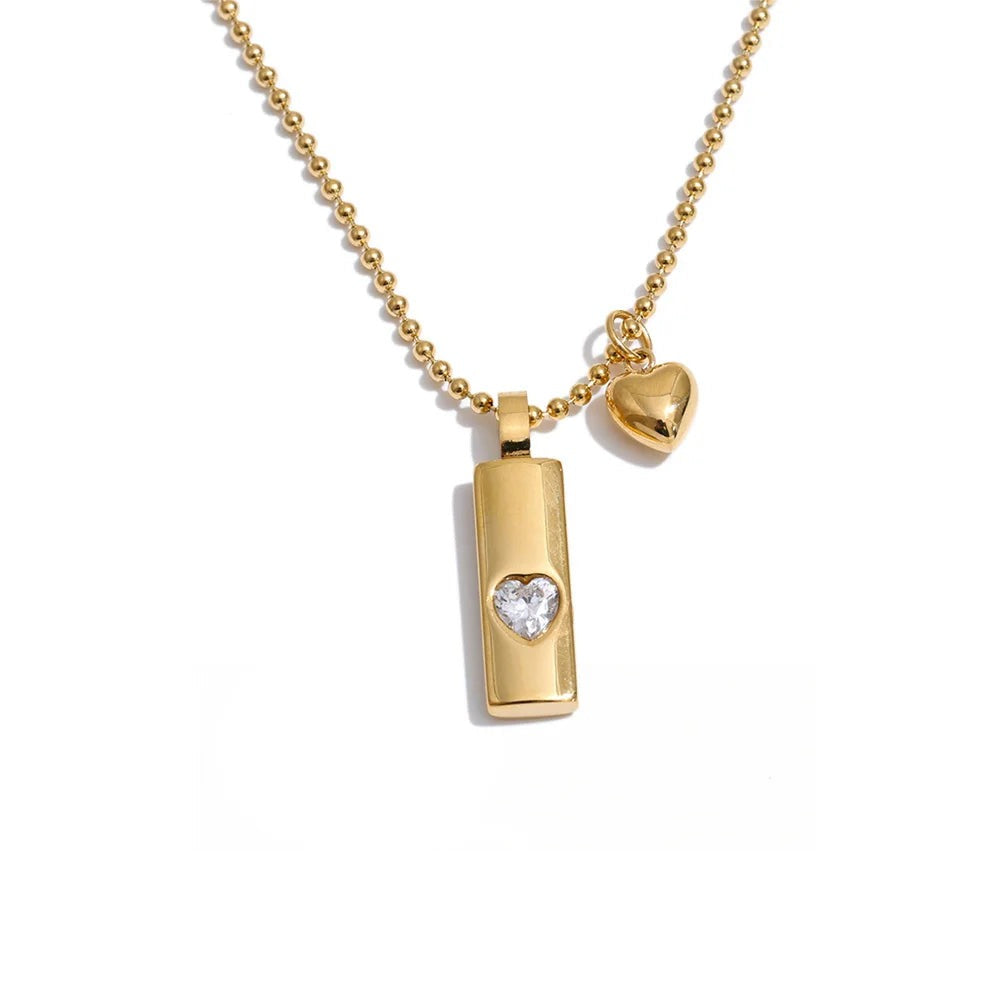 Gold-plated stainless steel necklace with cubic zirconia charm featuring a heart and a key.