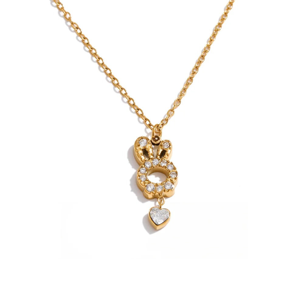 Gold-plated stainless steel necklace with cubic zirconia stones featuring a heart pendant and a small round charm.