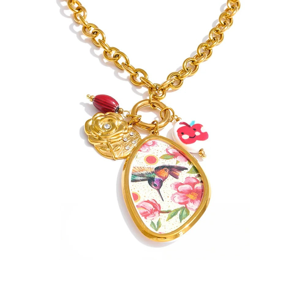 Gold-plated stainless steel necklace with cubic zirconia and resin pendants featuring a floral pattern and a bird charm.