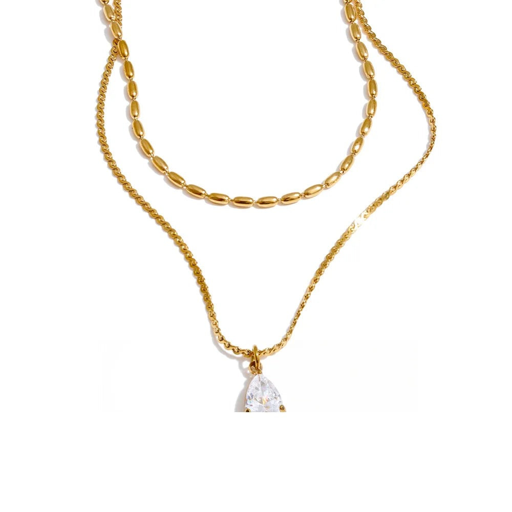 Gold-plated stainless steel necklace with cubic zirconia pendant.