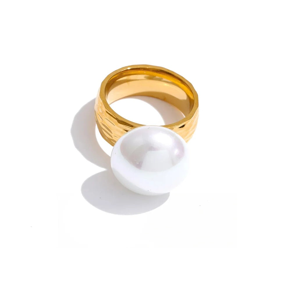 Gold-plated ring with pearl and shell.