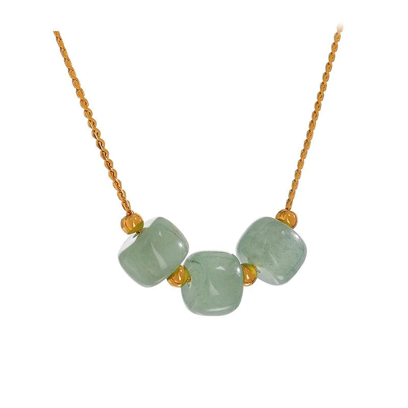 Gold-plated necklace with green stones.